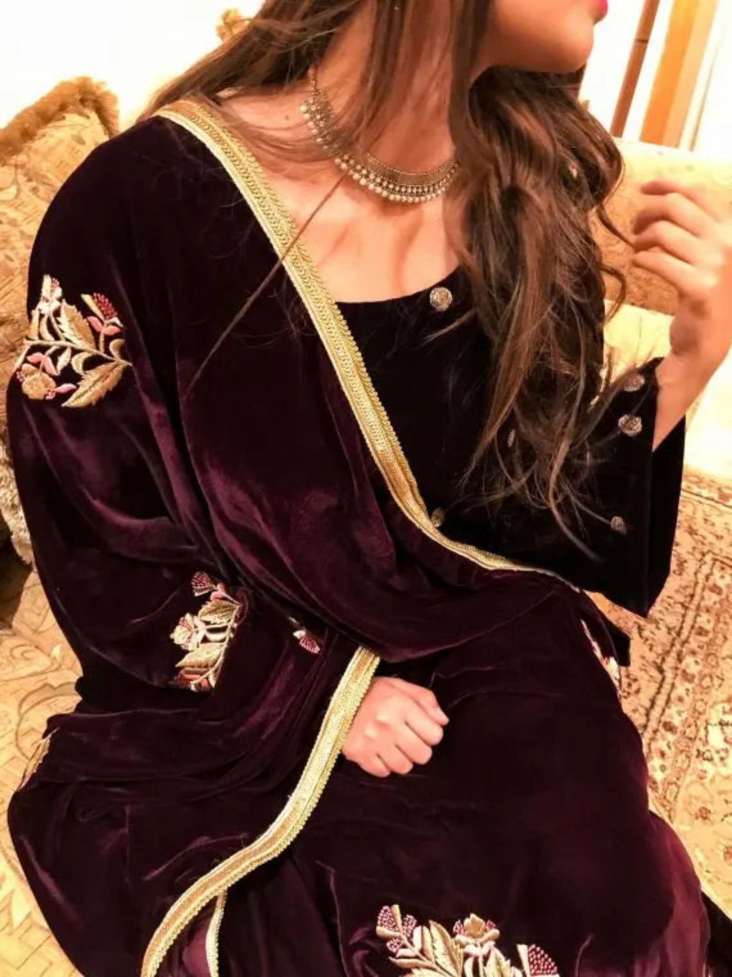 A luxurious velvet shawl featuring intricate gold embroidery and floral designs, exuding elegance, highlighting refined craftsmanship  and sophistication.