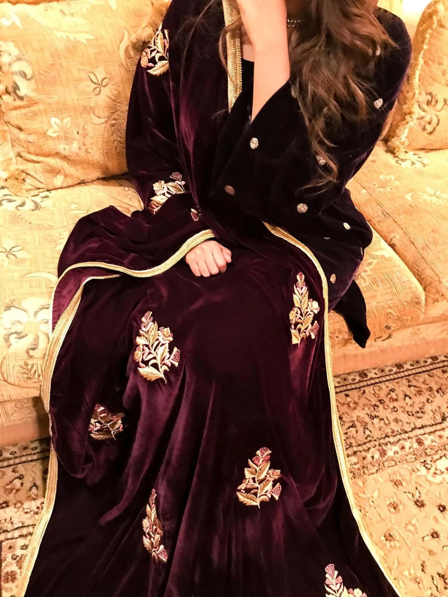 A luxurious velvet shawl featuring intricate gold embroidery and floral designs, exuding elegance, highlighting refined craftsmanship  and sophistication.