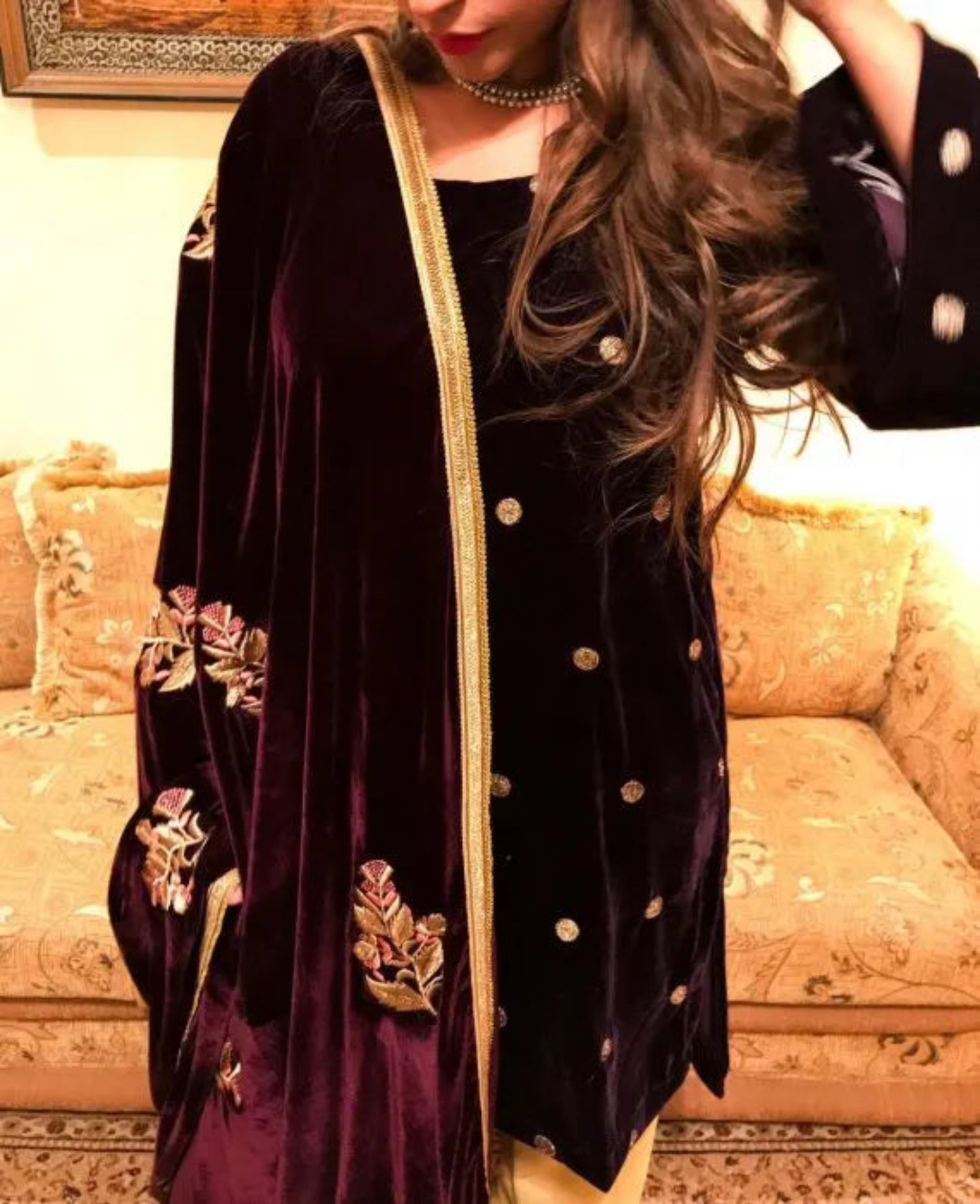 A luxurious velvet shawl featuring intricate gold embroidery and floral designs, exuding elegance, highlighting refined craftsmanship  and sophistication.