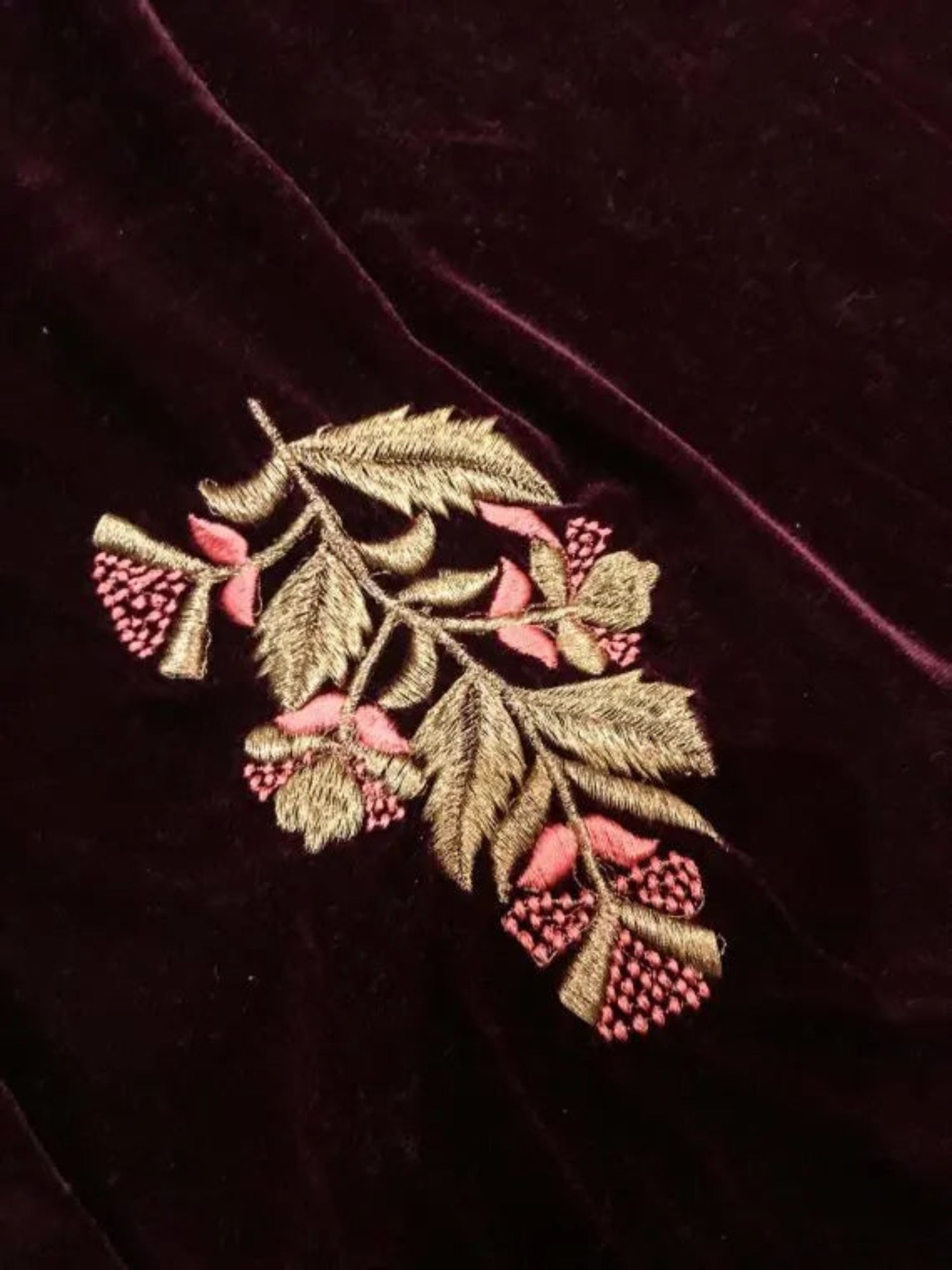 A luxurious velvet shawl featuring intricate gold embroidery and floral designs, exuding elegance, highlighting refined craftsmanship  and sophistication.