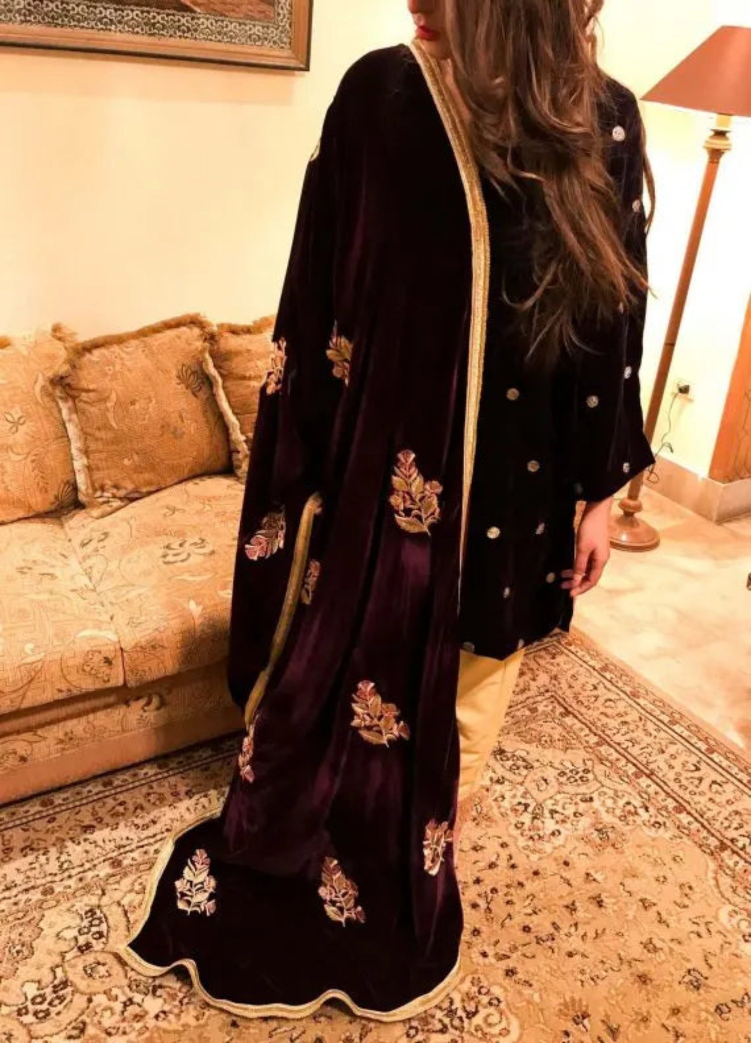 A luxurious velvet shawl featuring intricate gold embroidery and floral designs, exuding elegance, highlighting refined craftsmanship  and sophistication.