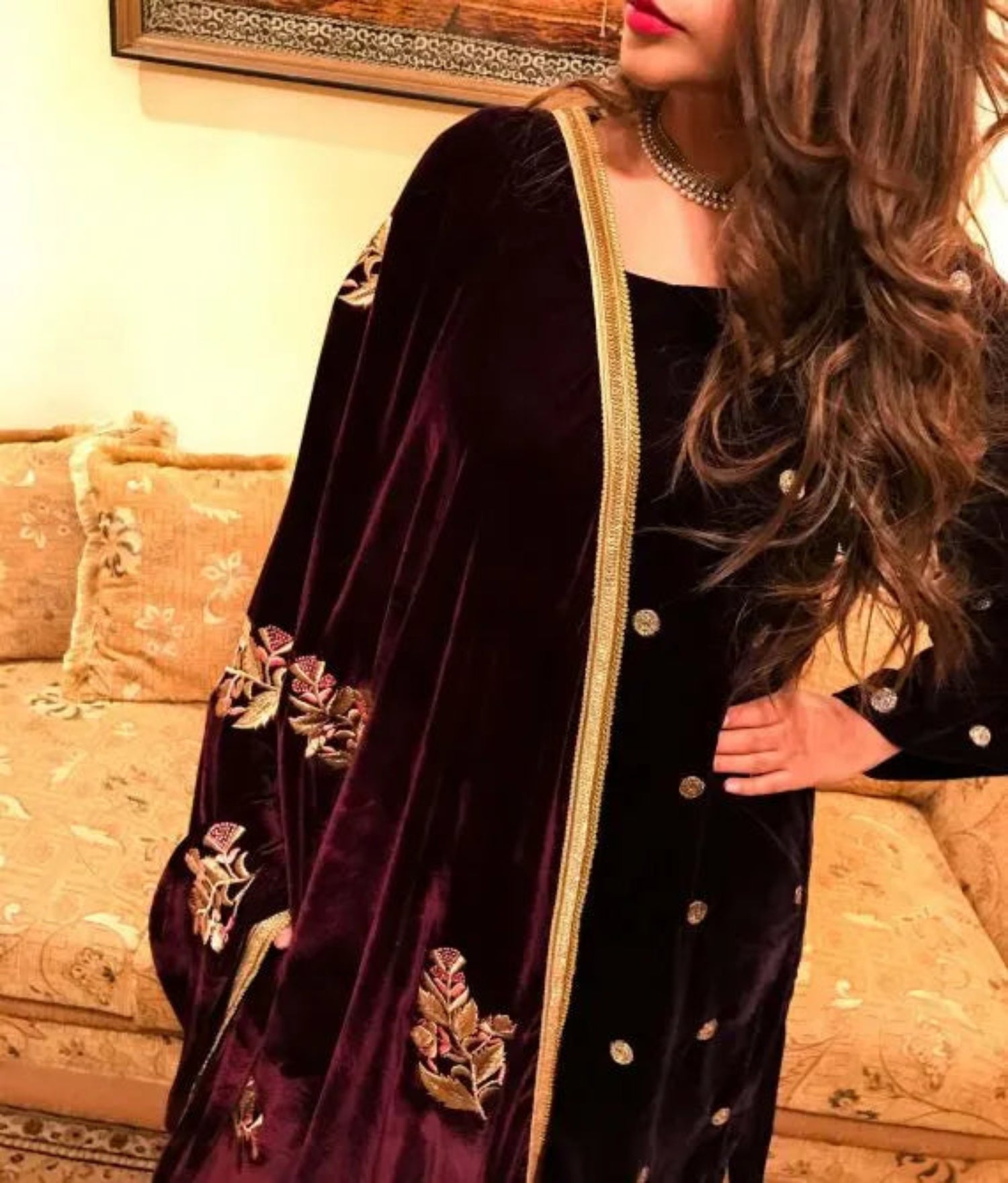 A luxurious velvet shawl featuring intricate gold embroidery and floral designs, exuding elegance, highlighting refined craftsmanship  and sophistication.