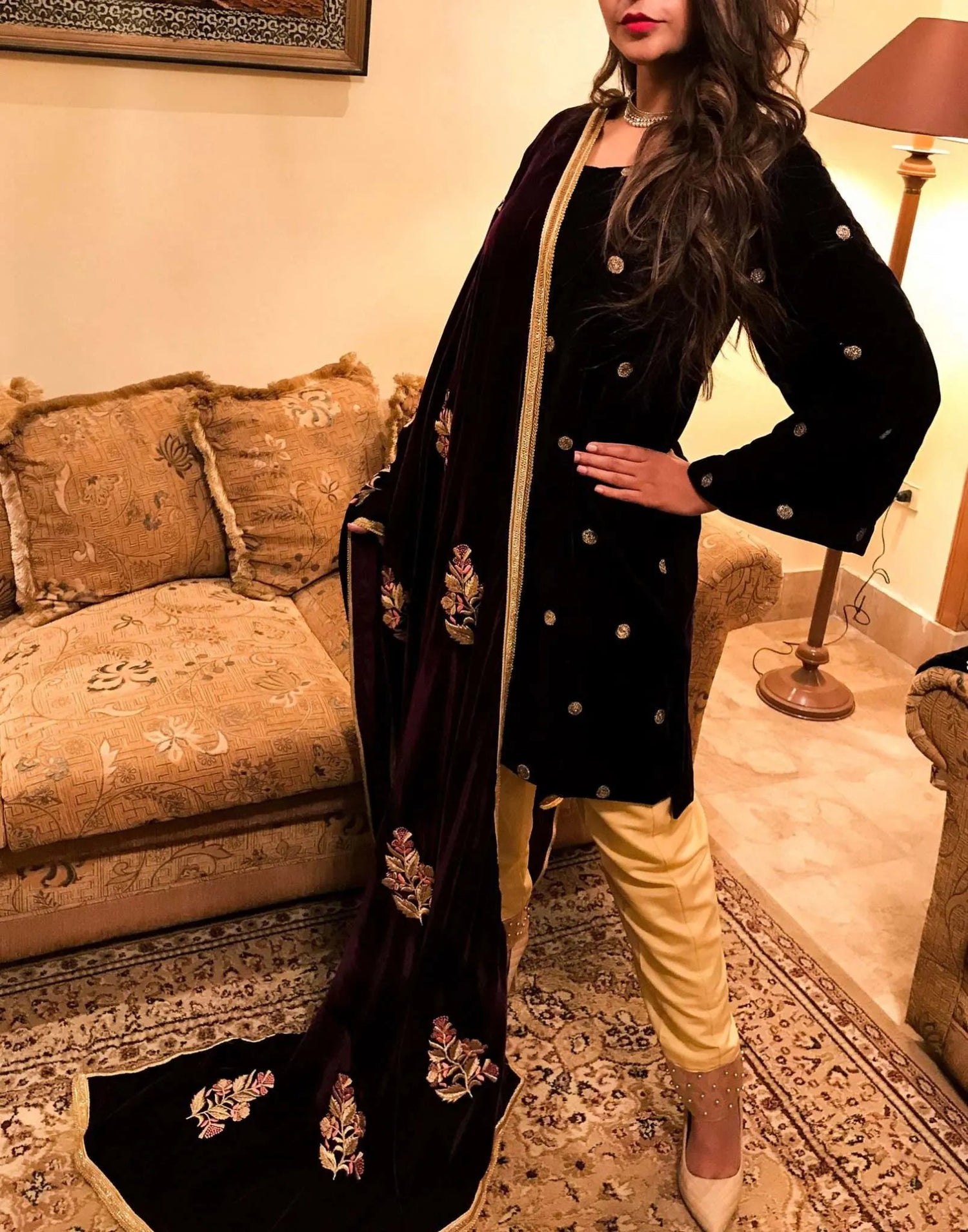 A luxurious velvet shawl featuring intricate gold embroidery and floral designs, exuding elegance, highlighting refined craftsmanship  and sophistication.