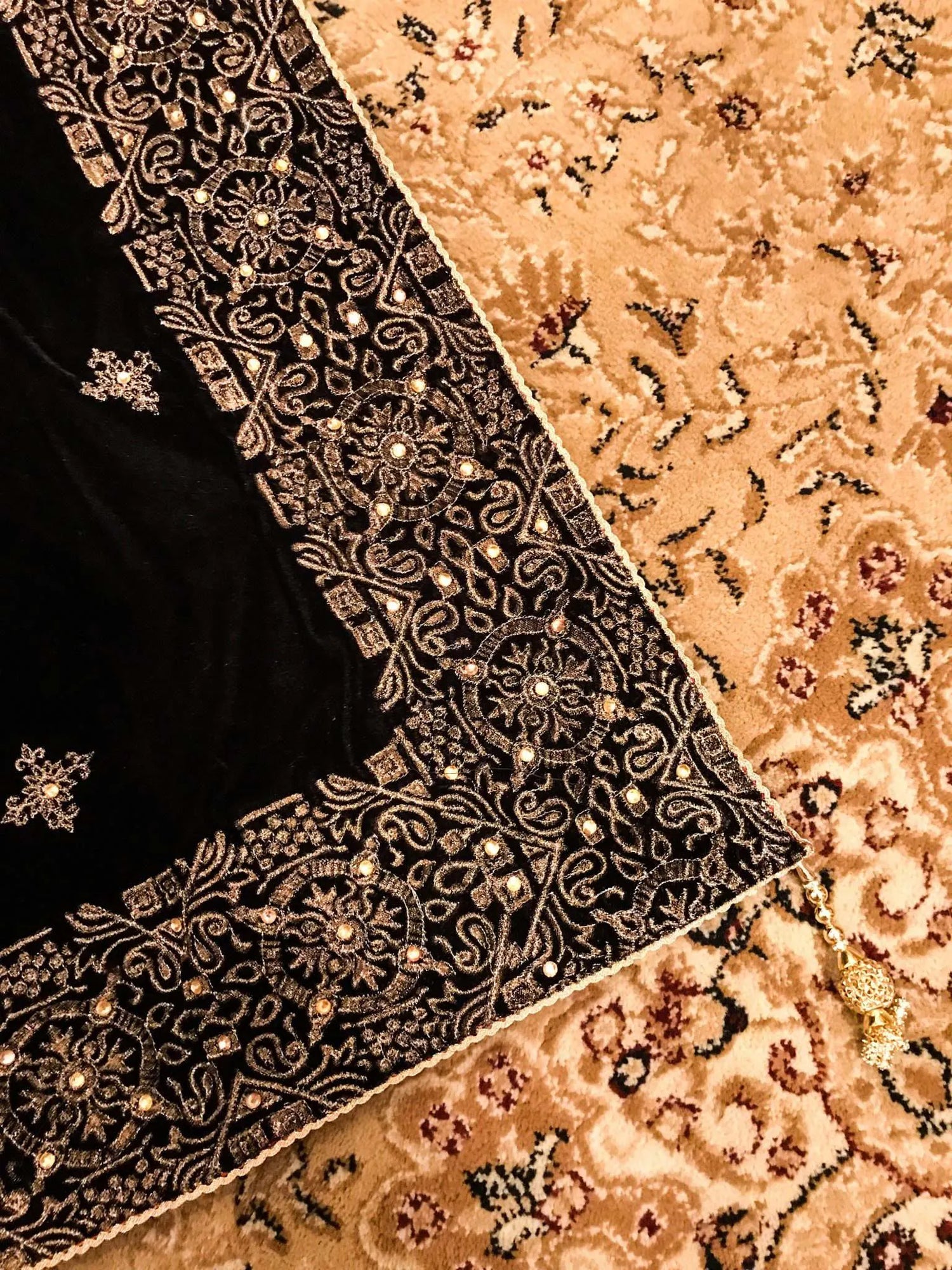Luxurious velvet shawl adorned with gold tila embroidery, stone work and tassels, ideal for enhancing festive and formal attire.