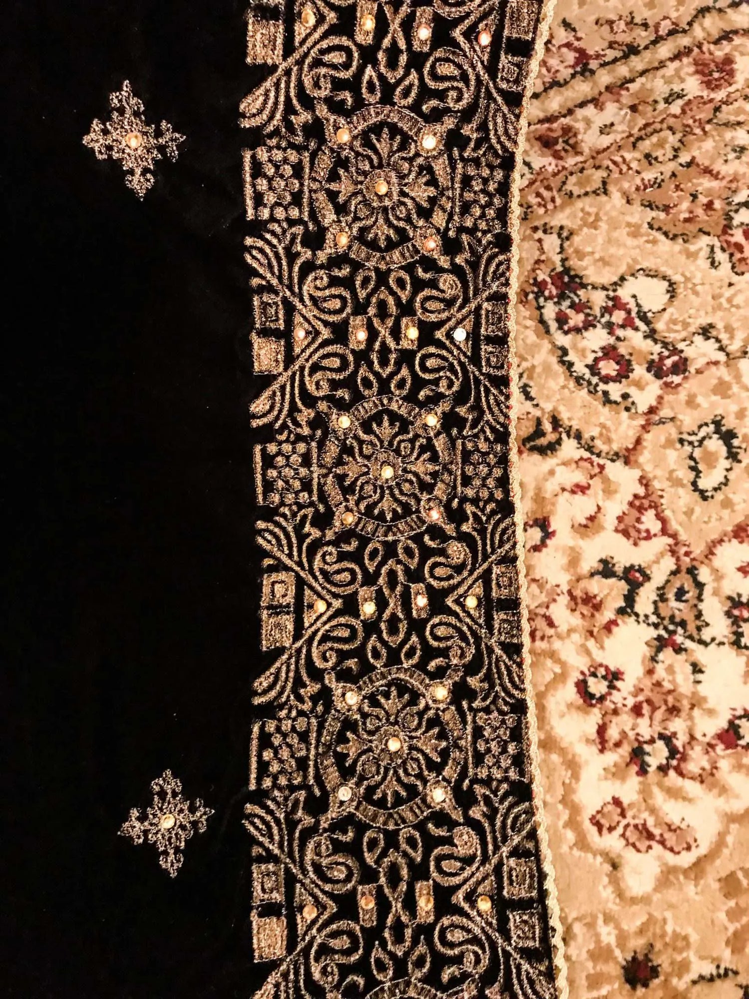 Luxurious velvet shawl adorned with gold tila embroidery, stone work and tassels, ideal for enhancing festive and formal attire.