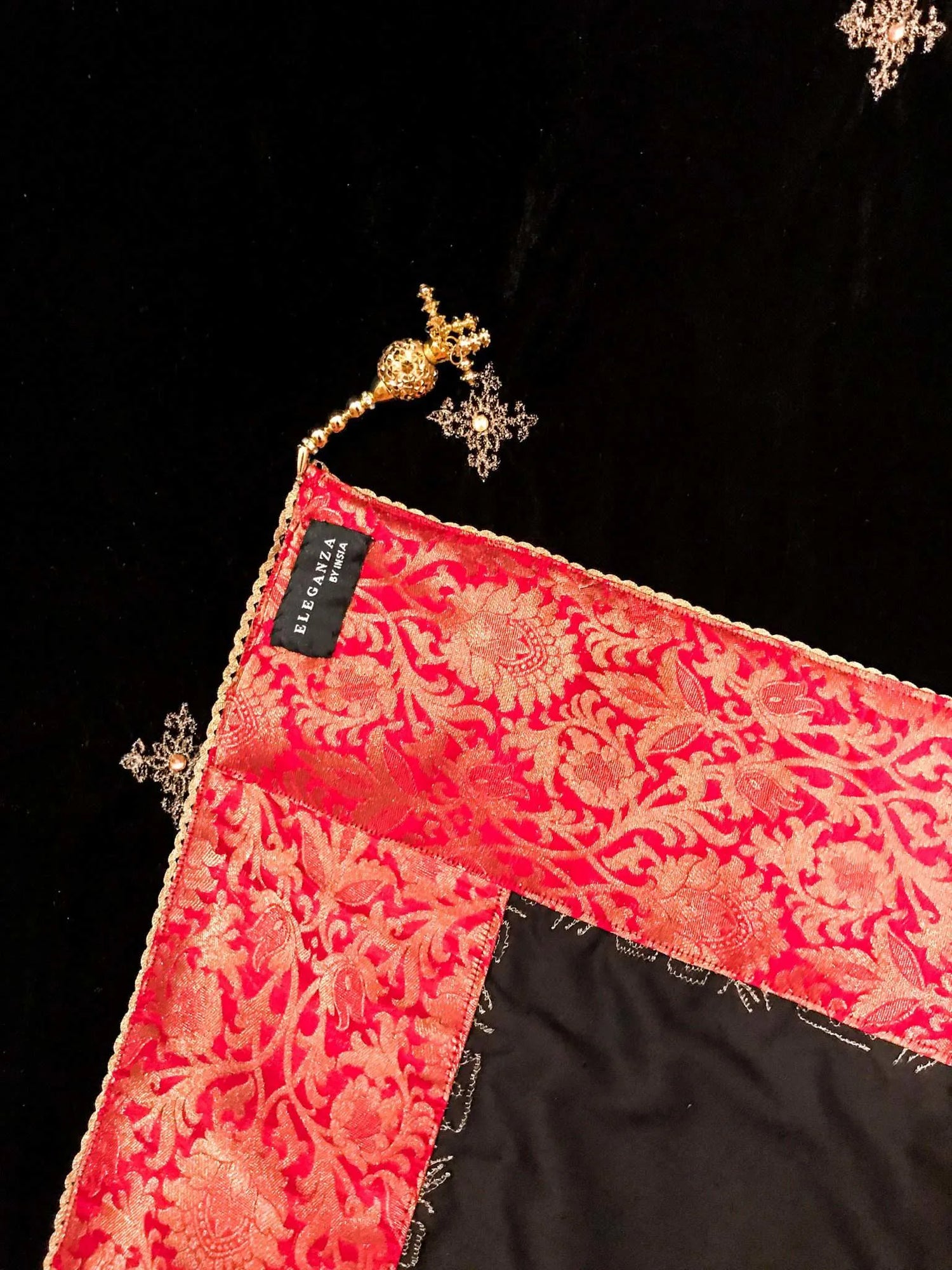 Luxurious velvet shawl adorned with gold tila embroidery, stone work and tassels, ideal for enhancing festive and formal attire.