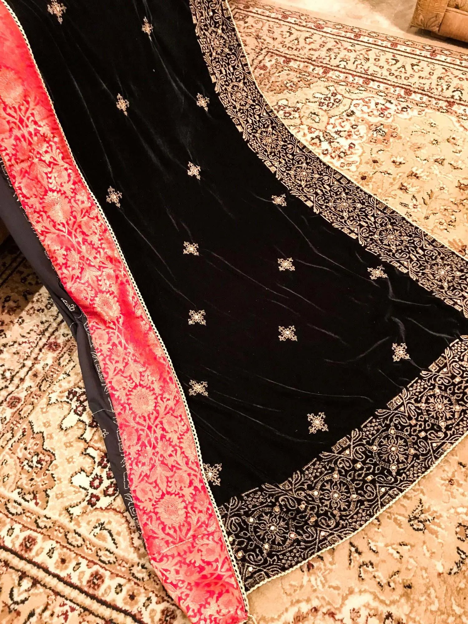 Luxurious velvet shawl adorned with gold tila embroidery, stone work and tassels, ideal for enhancing festive and formal attire.