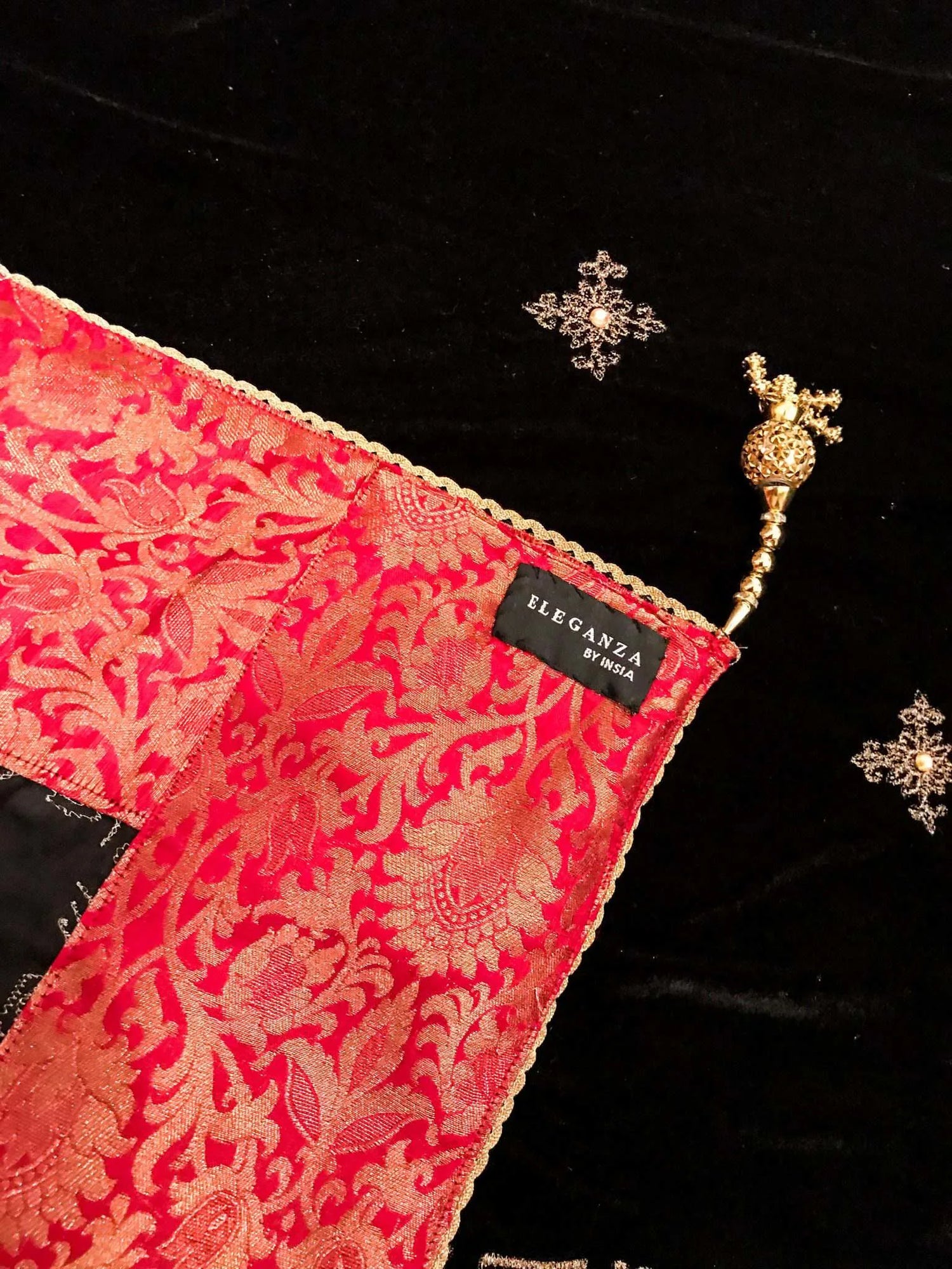Luxurious velvet shawl adorned with gold tila embroidery, stone work and tassels, ideal for enhancing festive and formal attire.
