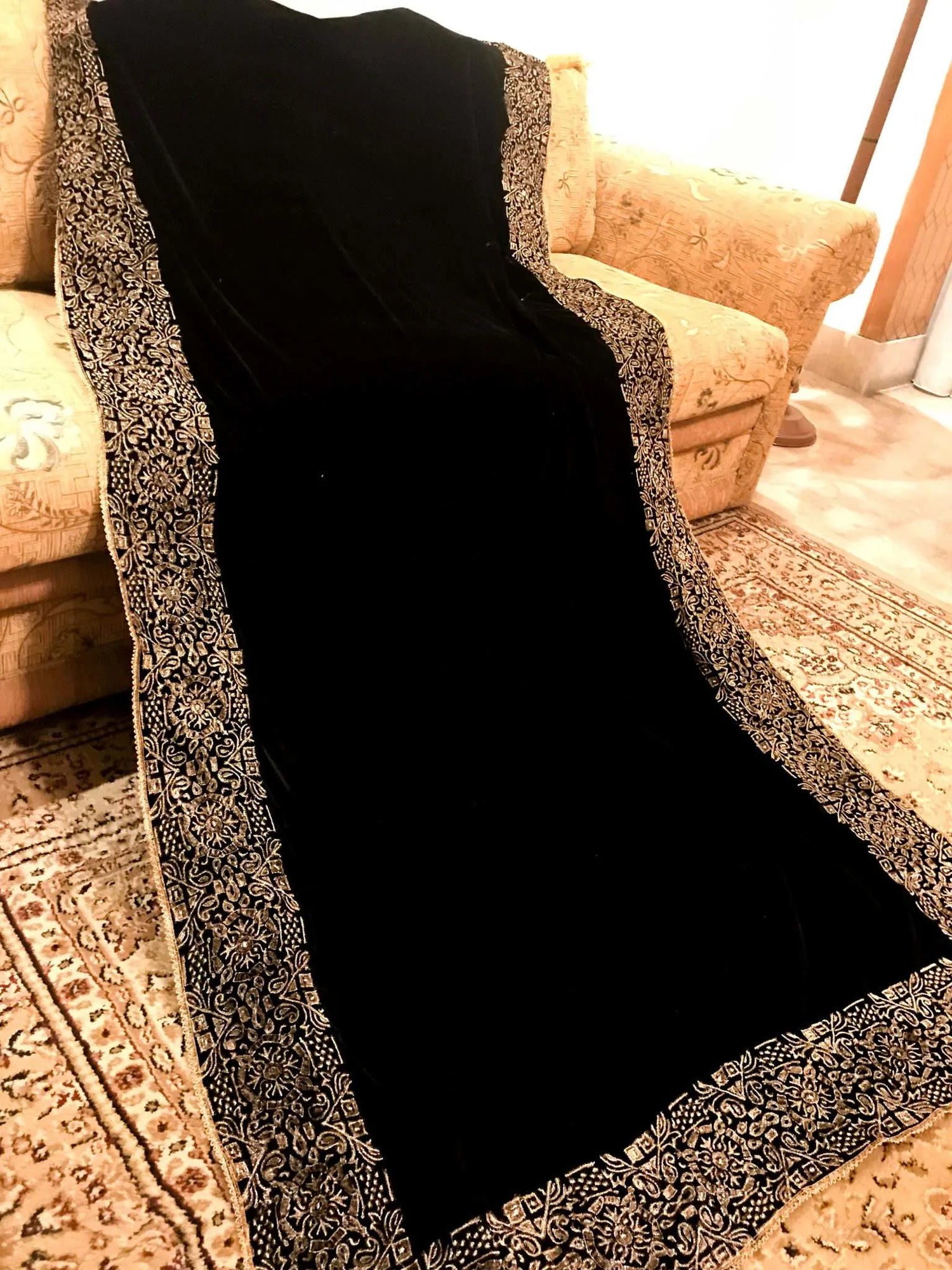 Elegant velvet shawl with a golden border, adorned with geometric block printed motifs and tila embroidery, perfect for formal occasions.