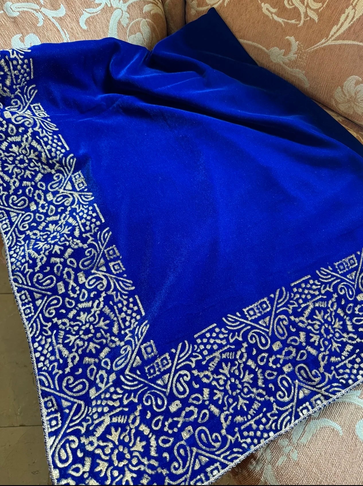 Elegant velvet shawl with a golden border, adorned with geometric block printed motifs and tila embroidery, perfect for formal occasions.