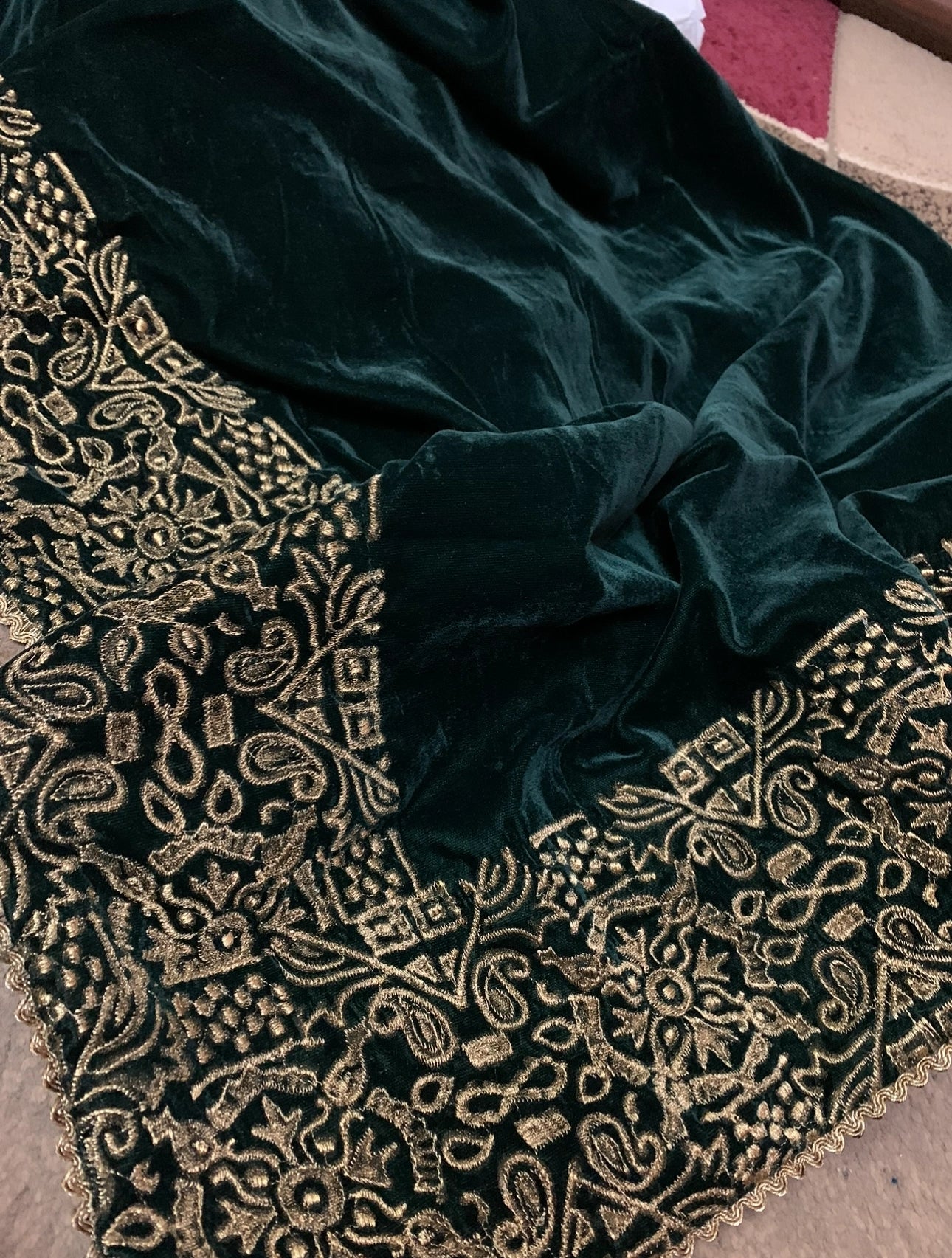 Elegant velvet shawl with a golden border, adorned with geometric block printed motifs and tila embroidery, perfect for formal occasions.