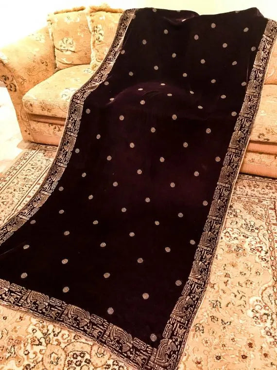 Luxurious velvet shawl featuring floral motifs and an exquisite Egyptian-inspired border, perfect for formal occasions.