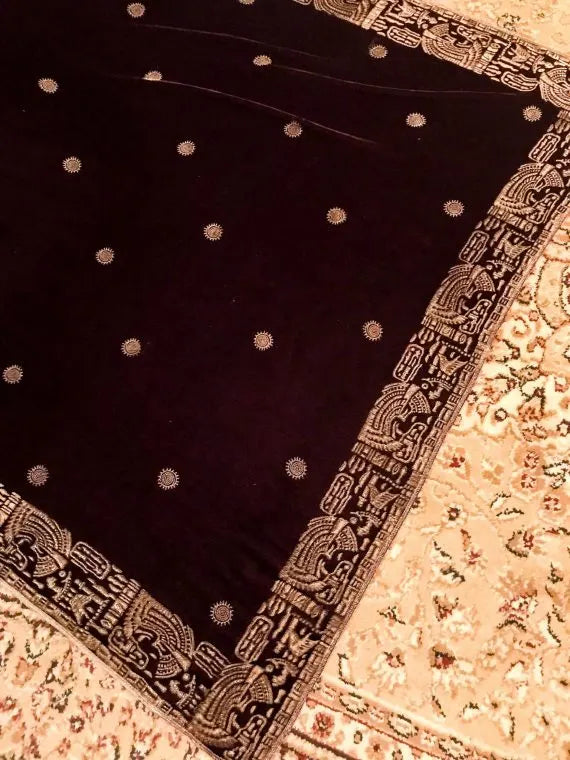 Luxurious velvet shawl featuring floral motifs and an exquisite Egyptian-inspired border, perfect for formal occasions.