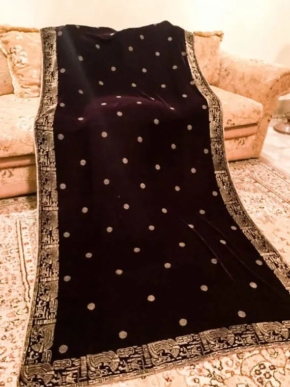 Luxurious velvet shawl featuring floral motifs and an exquisite Egyptian-inspired border, perfect for formal occasions.