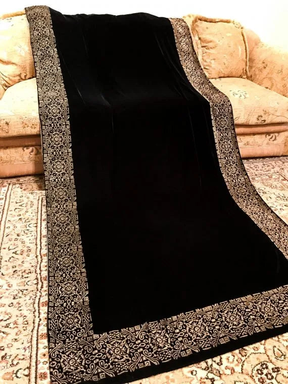 A velvet shawl showcasing a beautifully hand-block printed geometric design on all four edges, ideal for festive occasions. 