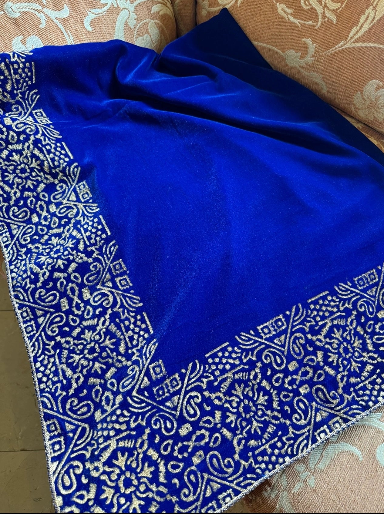 A velvet shawl showcasing a beautifully hand-block printed geometric design on all four edges, ideal for festive occasions. 
