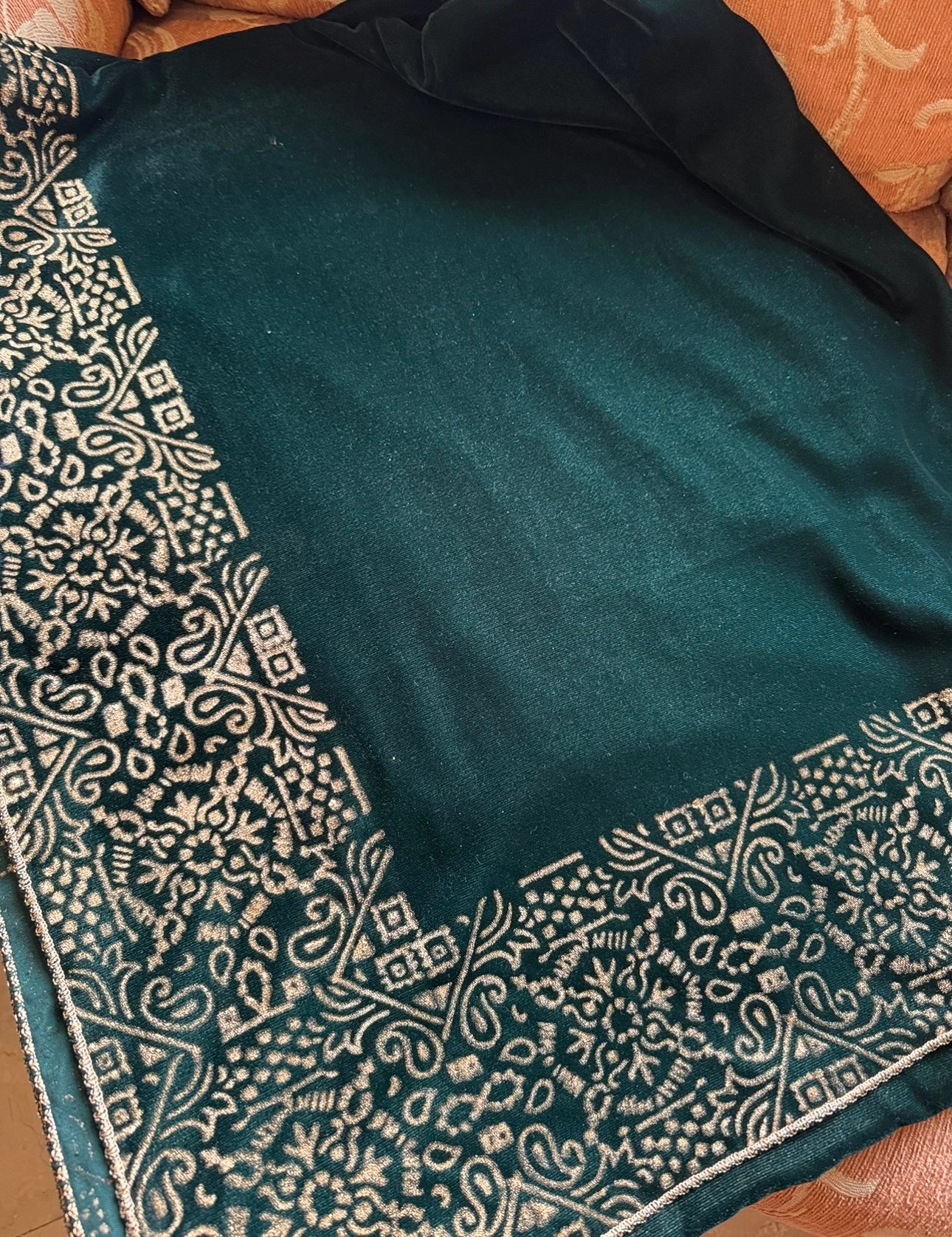 A velvet shawl showcasing a beautifully hand-block printed geometric design on all four edges, ideal for festive occasions. 