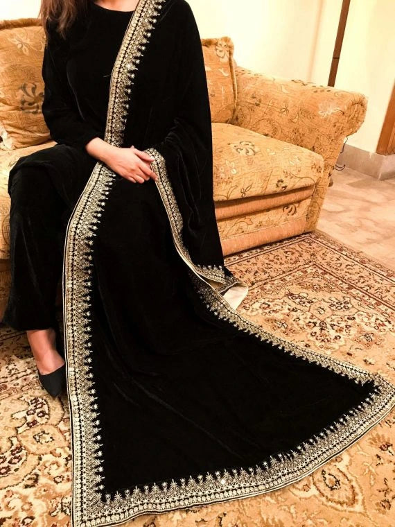 A sophisticated velvet shawl adorned with a luxurious intricate tila embroidery. Perfect for festive occasions and formal events.