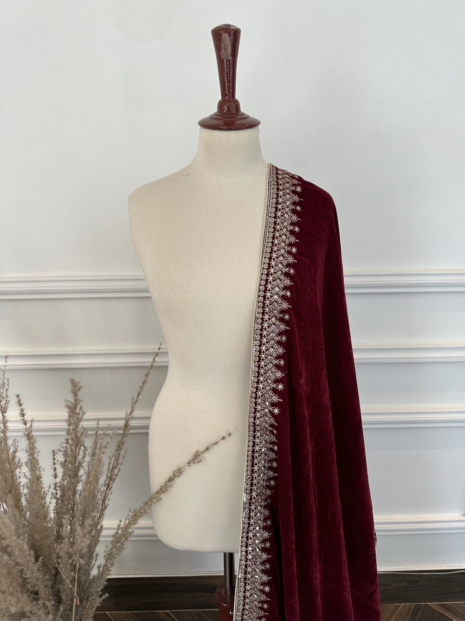 A sophisticated velvet shawl adorned with a luxurious intricate tila embroidery. Perfect for festive occasions and formal events.