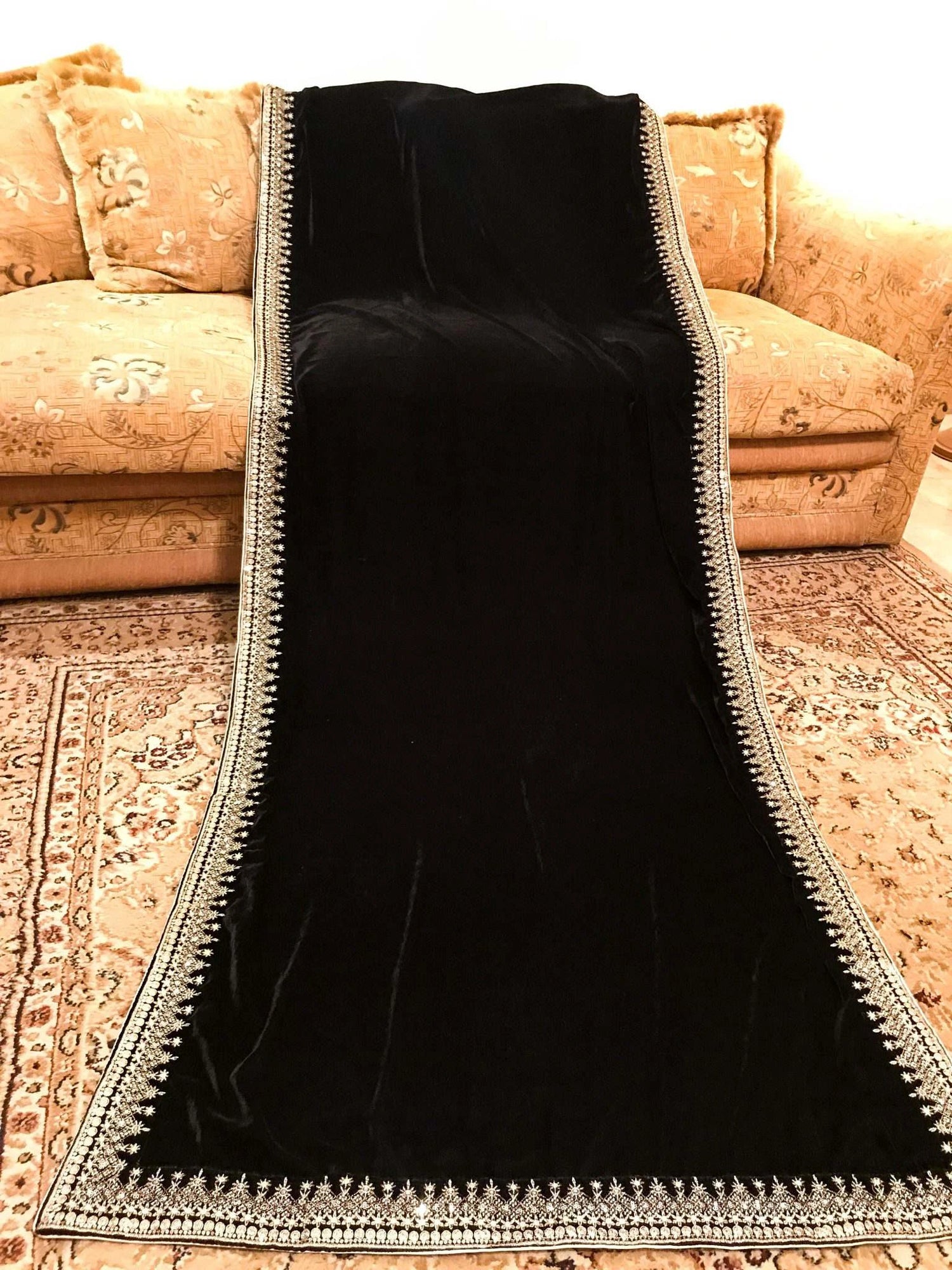 A sophisticated velvet shawl adorned with a luxurious intricate tila embroidery. Perfect for festive occasions and formal events.