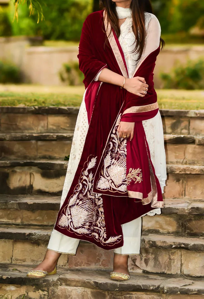 Elegant velvet shawl adored with intricate gota embroidery, featuring floral motifs and a satin silk edged border for glamorous look.