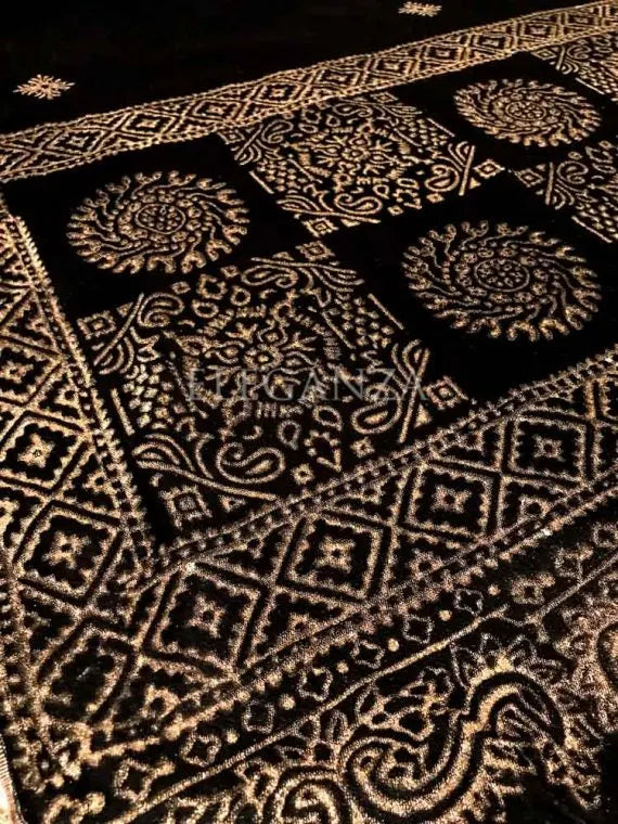 Luxurious velvet shawl featuring bold geometric and circular block prints on the pallu, small geometric motifs in the center, and a delicate golden-threaded border on all sides. ideal for festive occasions or elegant evening wear.