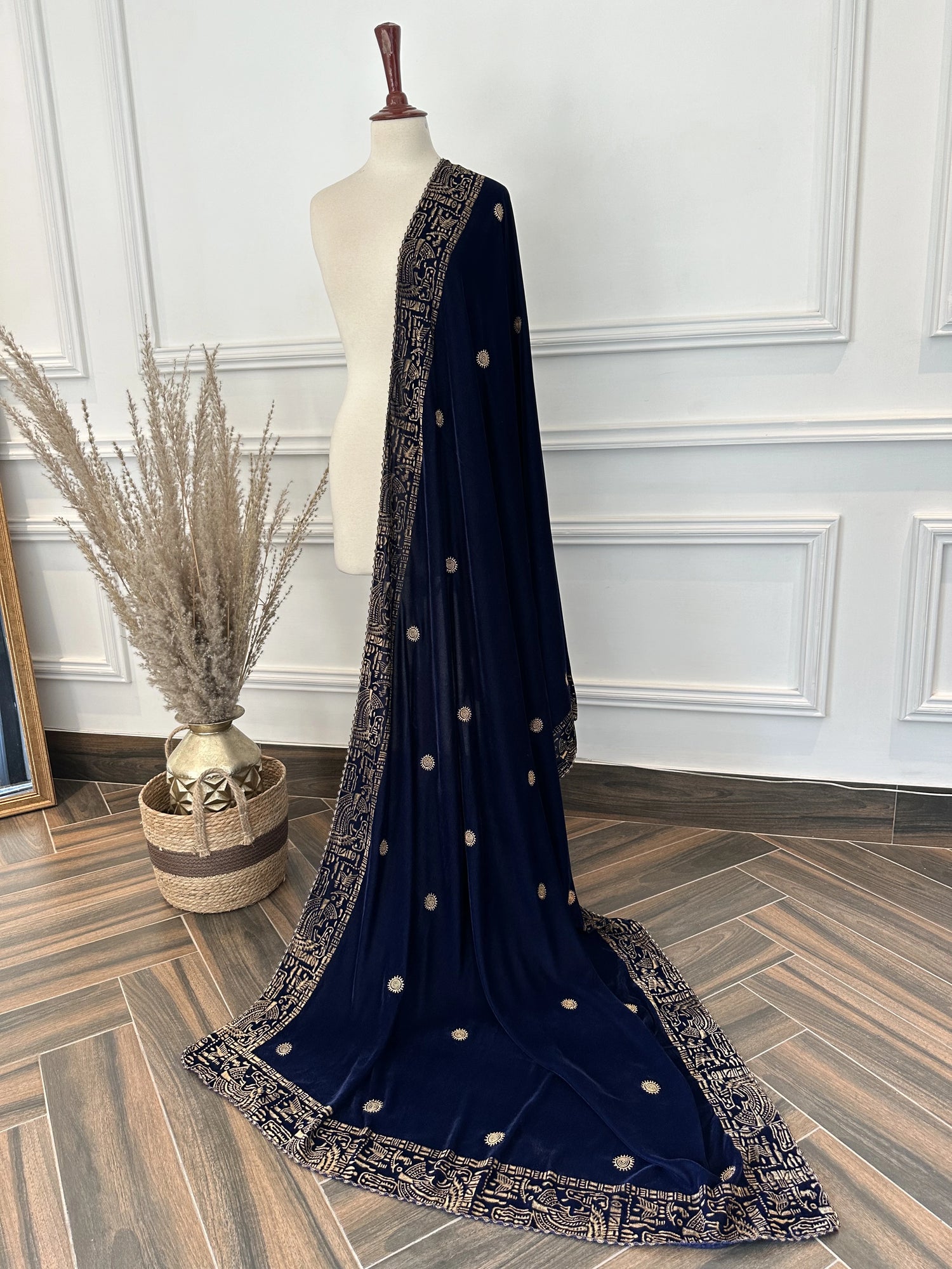 Elegant blue velvet shawl with gold tilla embroidery along a traditional border, featuring an all-over golden motif, perfect for festive and formal occasions.