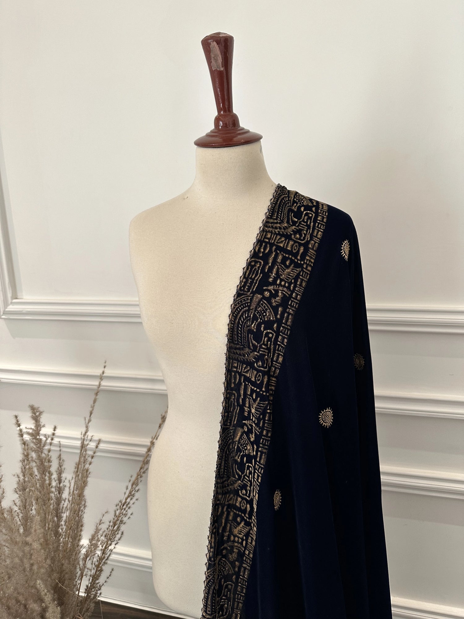 Elegant blue velvet shawl with gold tilla embroidery along a traditional border, featuring an all-over golden motif, perfect for festive and formal occasions.