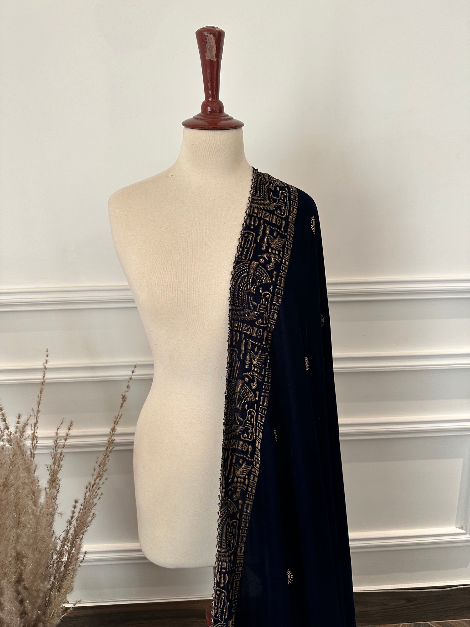 Elegant blue velvet shawl with gold tilla embroidery along a traditional border, featuring an all-over golden motif, perfect for festive and formal occasions.