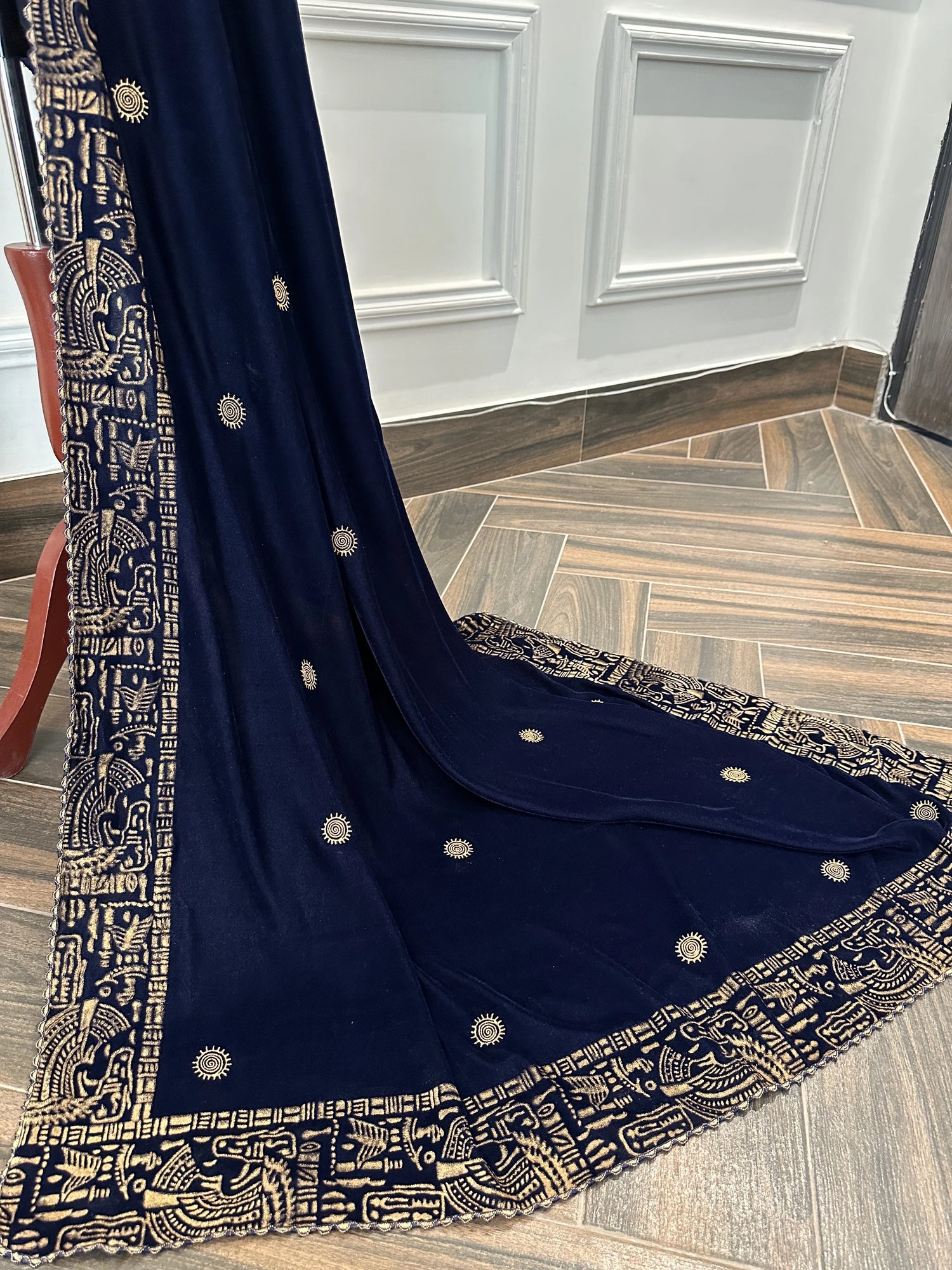 Elegant blue velvet shawl with gold tilla embroidery along a traditional border, featuring an all-over golden motif, perfect for festive and formal occasions.