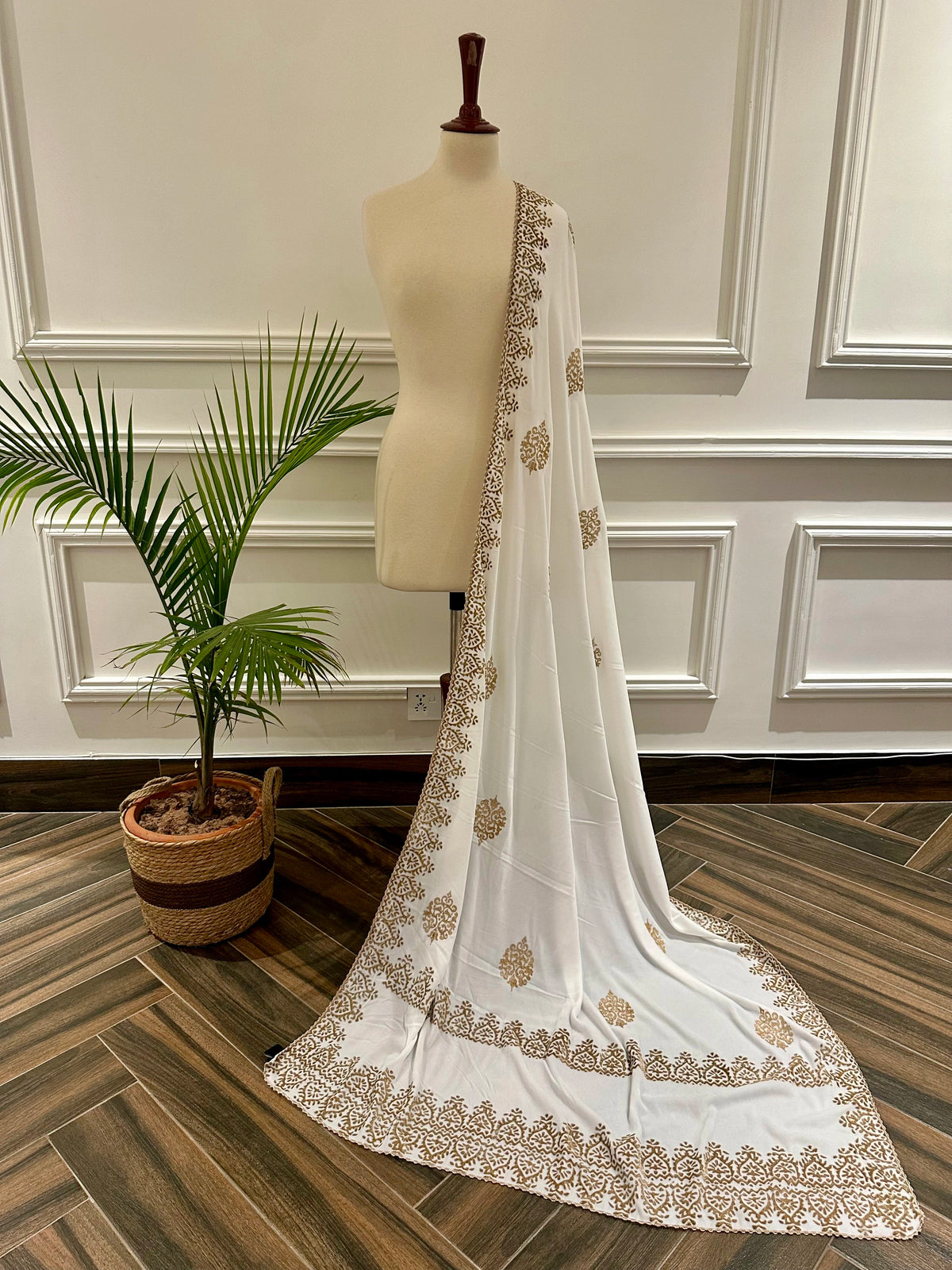 White and Gold Embroidery, a masterpiece of traditional craftsmanship, featuring a pristine white fabric adorned with intricate gold tilla embroidery and delicate florals motif.
