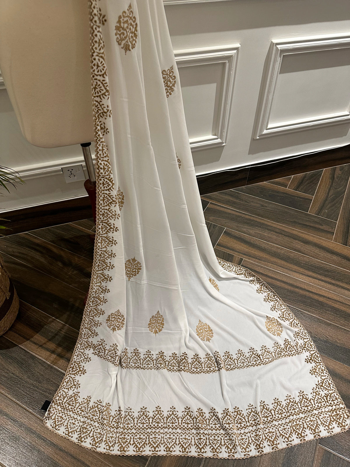 White and Gold Embroidery, a masterpiece of traditional craftsmanship, featuring a pristine white fabric adorned with intricate gold tilla embroidery and delicate florals motif.