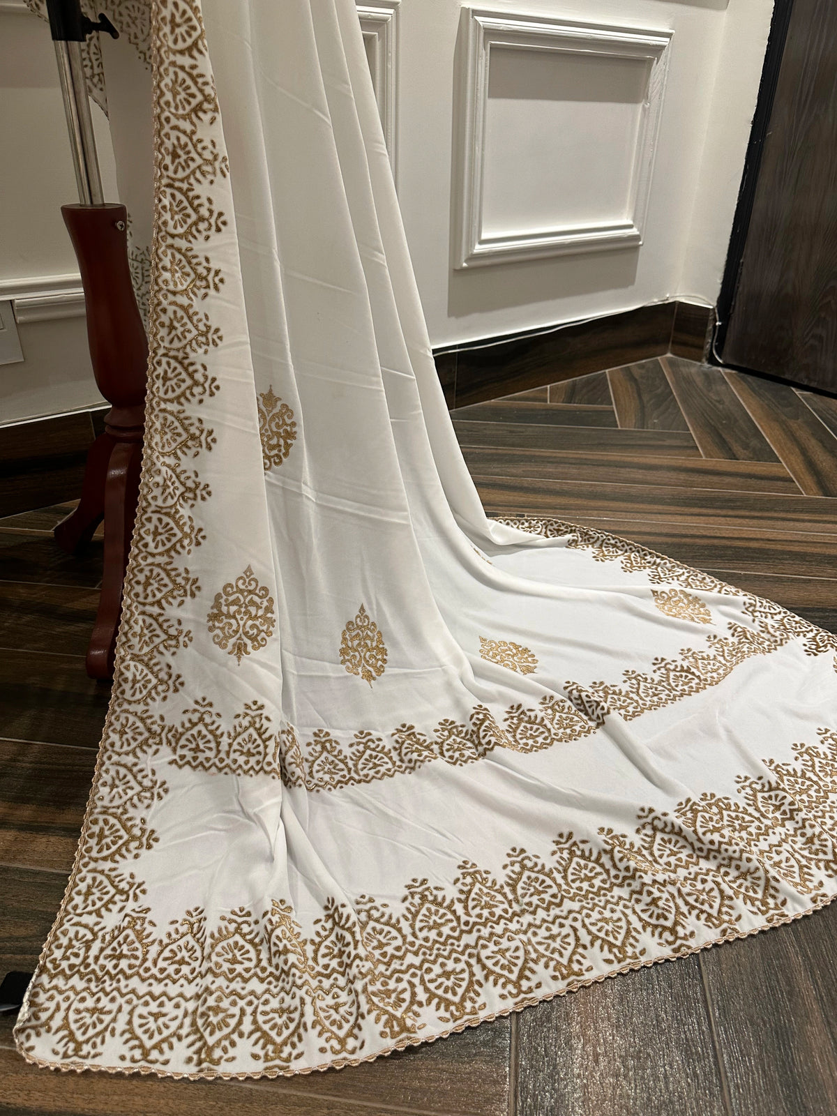 White and Gold Embroidery, a masterpiece of traditional craftsmanship, featuring a pristine white fabric adorned with intricate gold tilla embroidery and delicate florals motif.