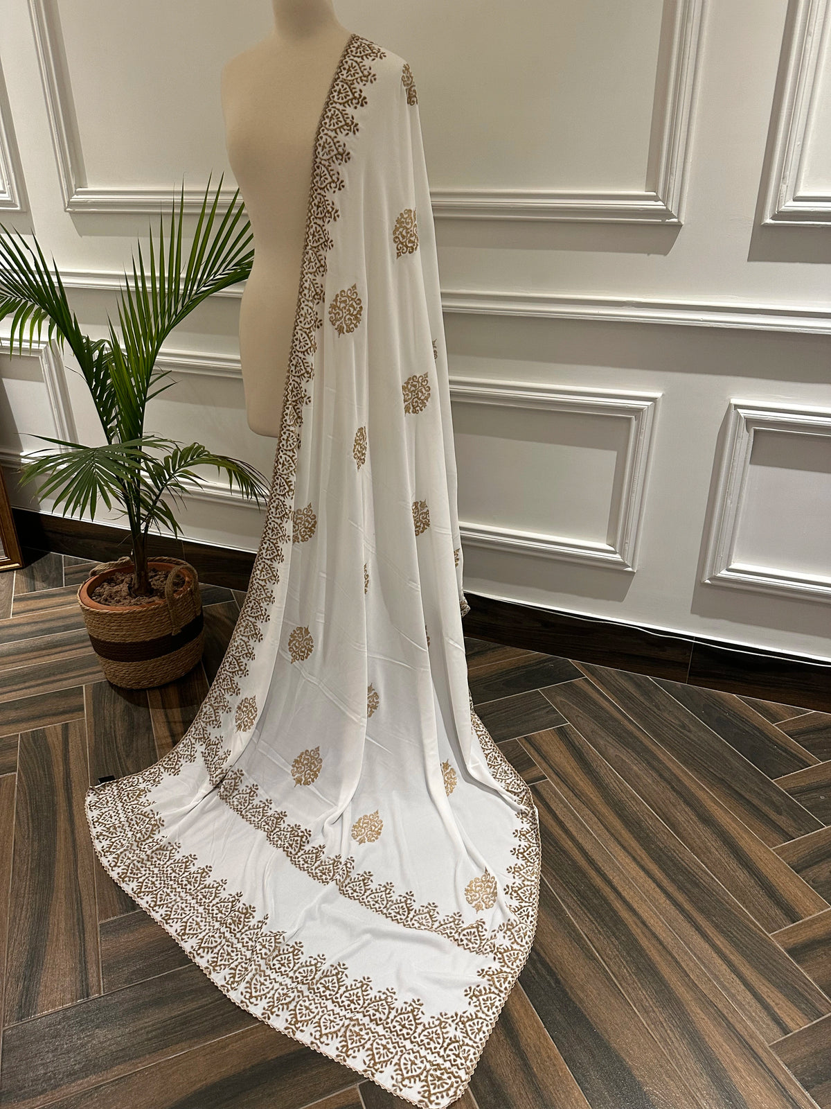 White and Gold Embroidery, a masterpiece of traditional craftsmanship, featuring a pristine white fabric adorned with intricate gold tilla embroidery and delicate florals motif.
