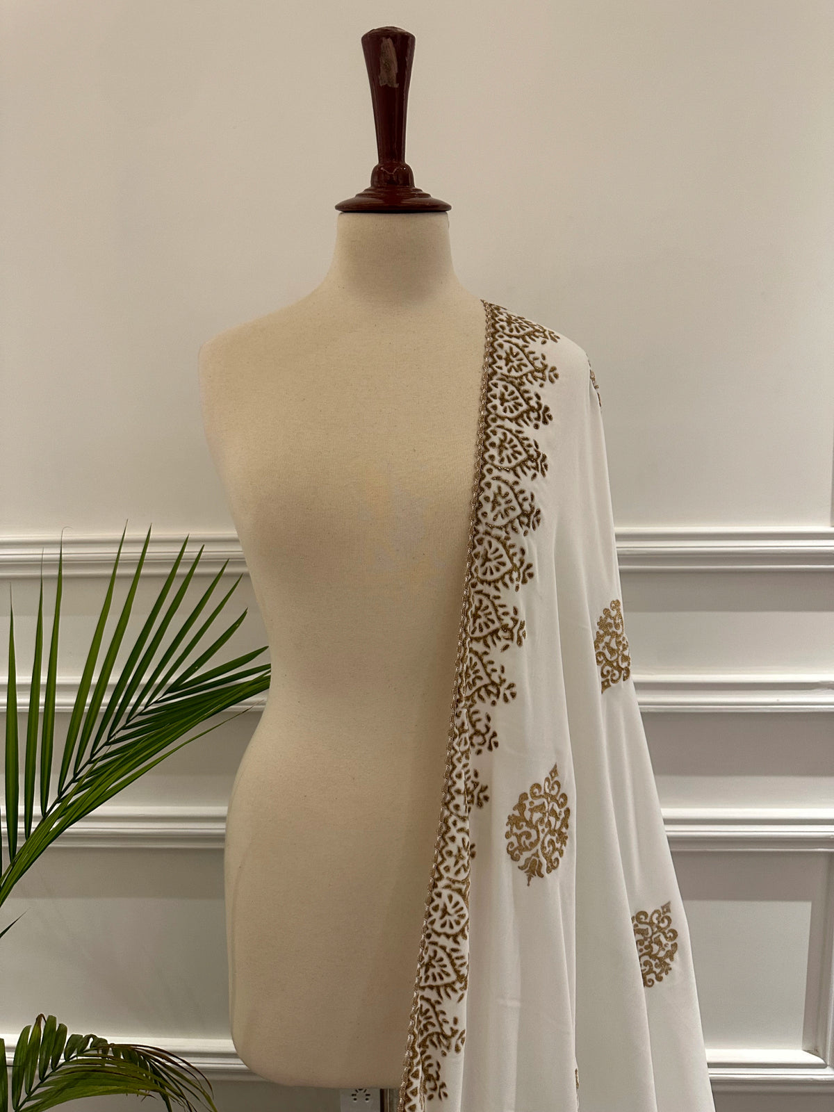 White and Gold Embroidery, a masterpiece of traditional craftsmanship, featuring a pristine white fabric adorned with intricate gold tilla embroidery and delicate florals motif.