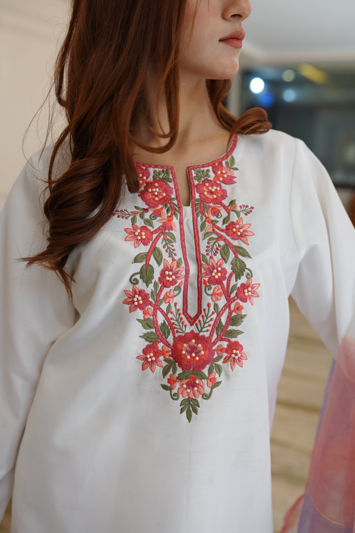 White dress paired with pink and lilac color showcasing refined style and grace.