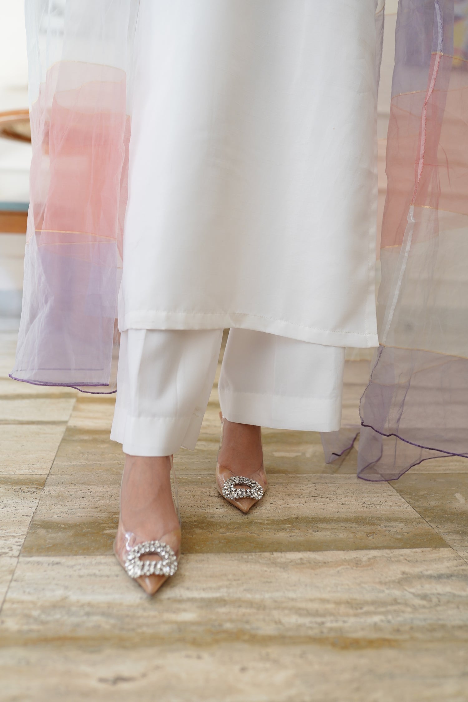 White dress paired with pink and lilac color showcasing refined style and grace.