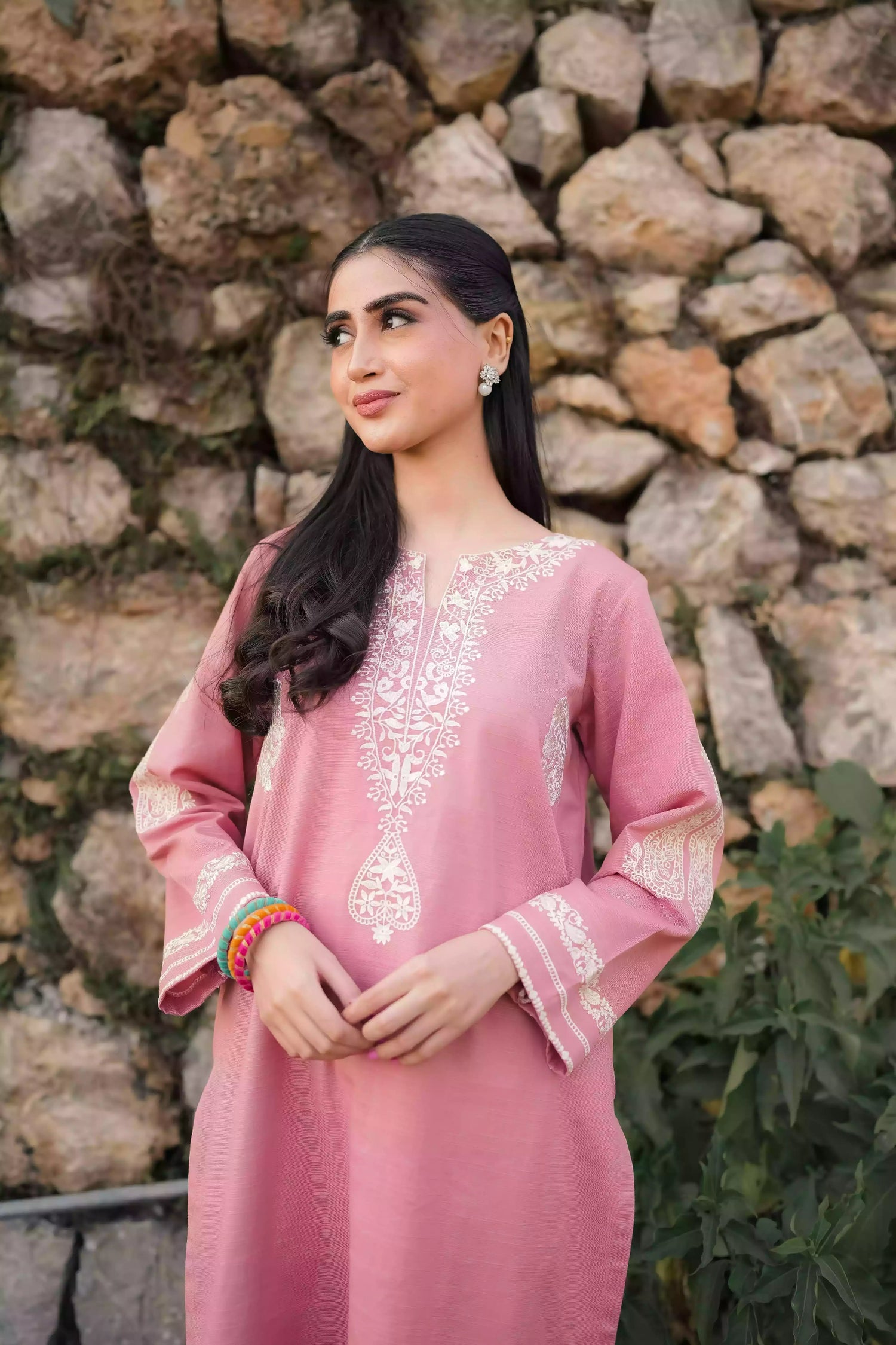 Soft pink kurta featuring intricate white embroidery on the neckline and sleeves. Made from breathable fabric with a relaxed silhouette, the outfit blends traditional elegance with comfortable, refined style suitable for everyday wear or festive occasions.