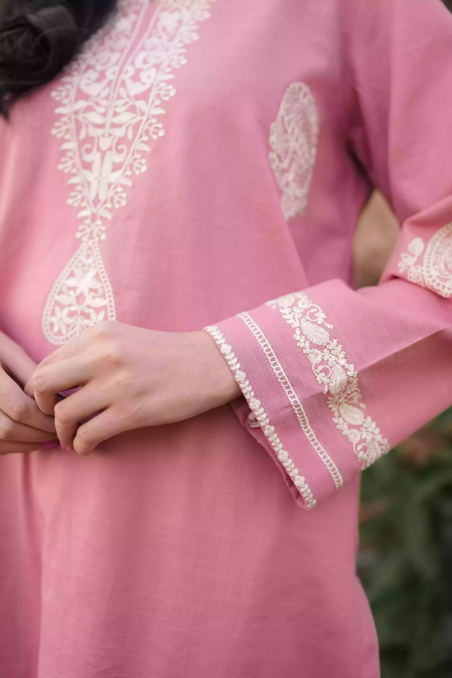 Soft pink kurta featuring intricate white embroidery on the neckline and sleeves. Made from breathable fabric with a relaxed silhouette, the outfit blends traditional elegance with comfortable, refined style suitable for everyday wear or festive occasions.
