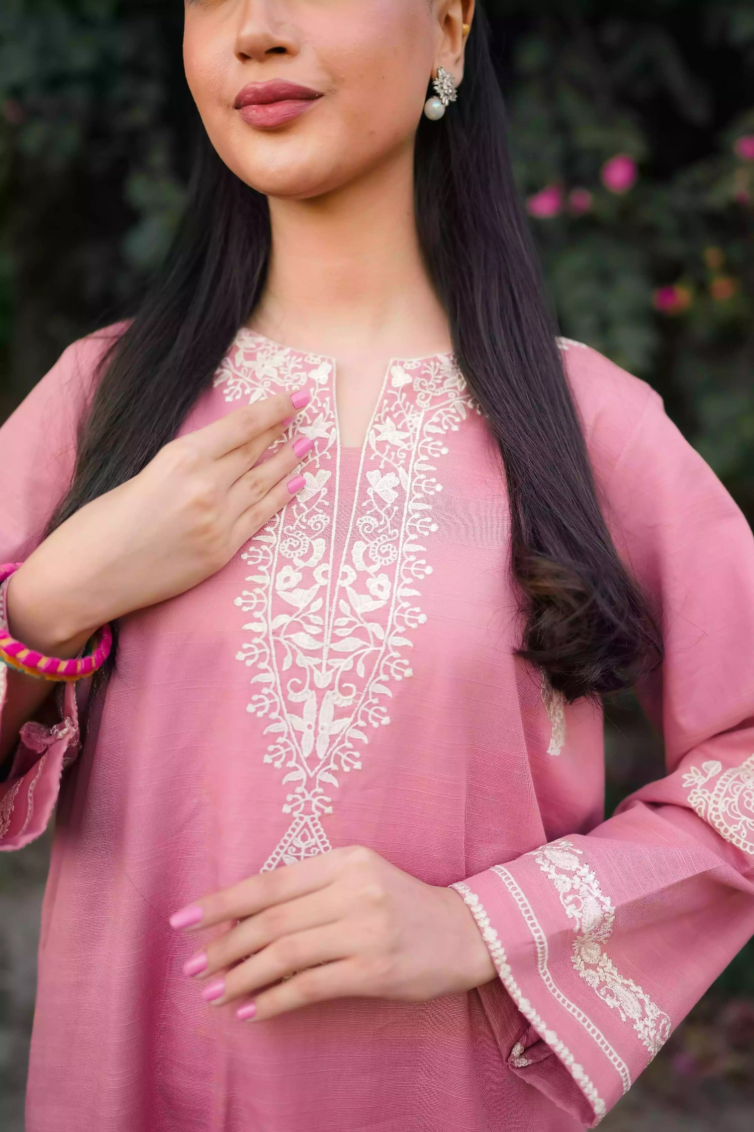 Soft pink kurta featuring intricate white embroidery on the neckline and sleeves. Made from breathable fabric with a relaxed silhouette, the outfit blends traditional elegance with comfortable, refined style suitable for everyday wear or festive occasions.
