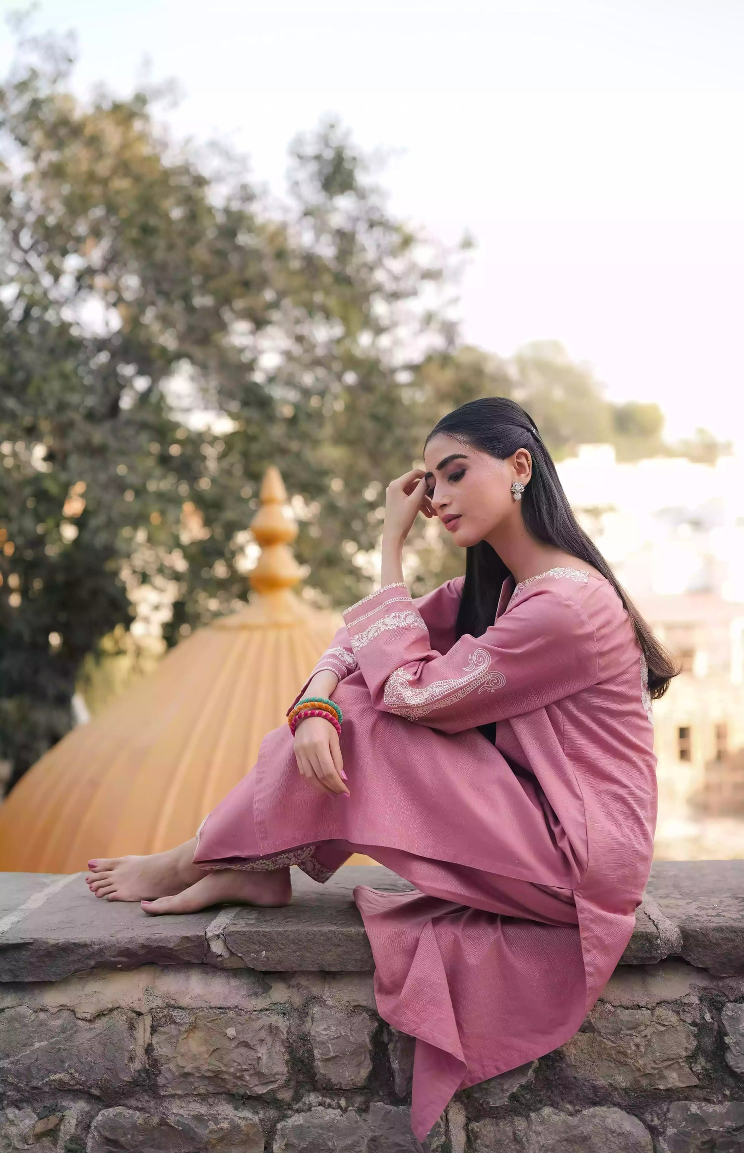 Soft pink kurta featuring intricate white embroidery on the neckline and sleeves. Made from breathable fabric with a relaxed silhouette, the outfit blends traditional elegance with comfortable, refined style suitable for everyday wear or festive occasions.