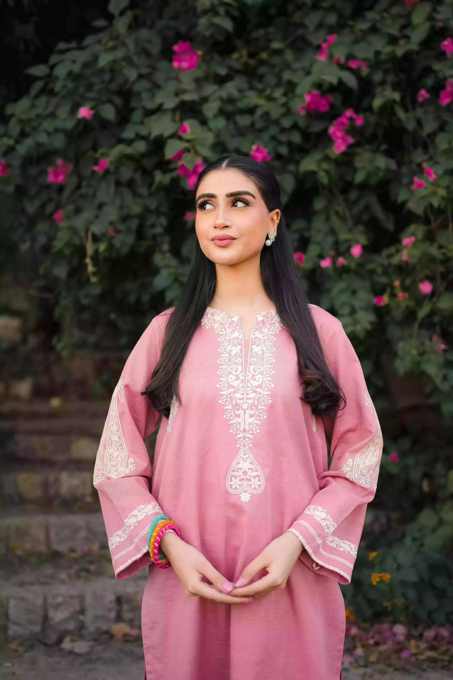 Soft pink kurta featuring intricate white embroidery on the neckline and sleeves. Made from breathable fabric with a relaxed silhouette, the outfit blends traditional elegance with comfortable, refined style suitable for everyday wear or festive occasions.