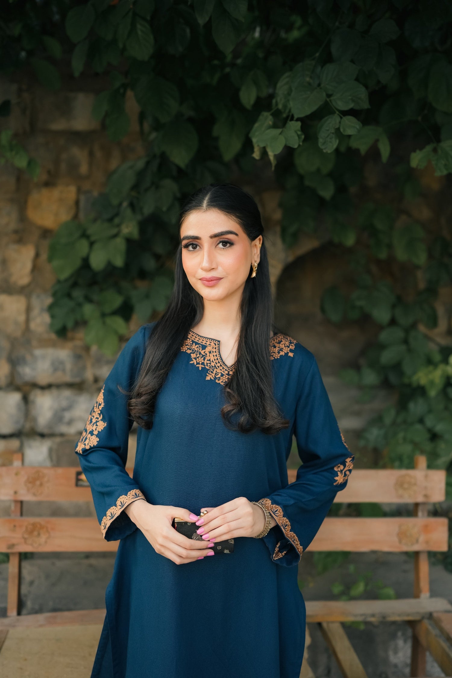 A Zinc blue ensemble featuring delicate light orange embroidery on the neckline, sleeves, and front with fine scattered motifs on the side. Soft threadwork paired with a matching shalwar. The outfit has an elegant, refined silhouette suitable for festive and everyday wear.