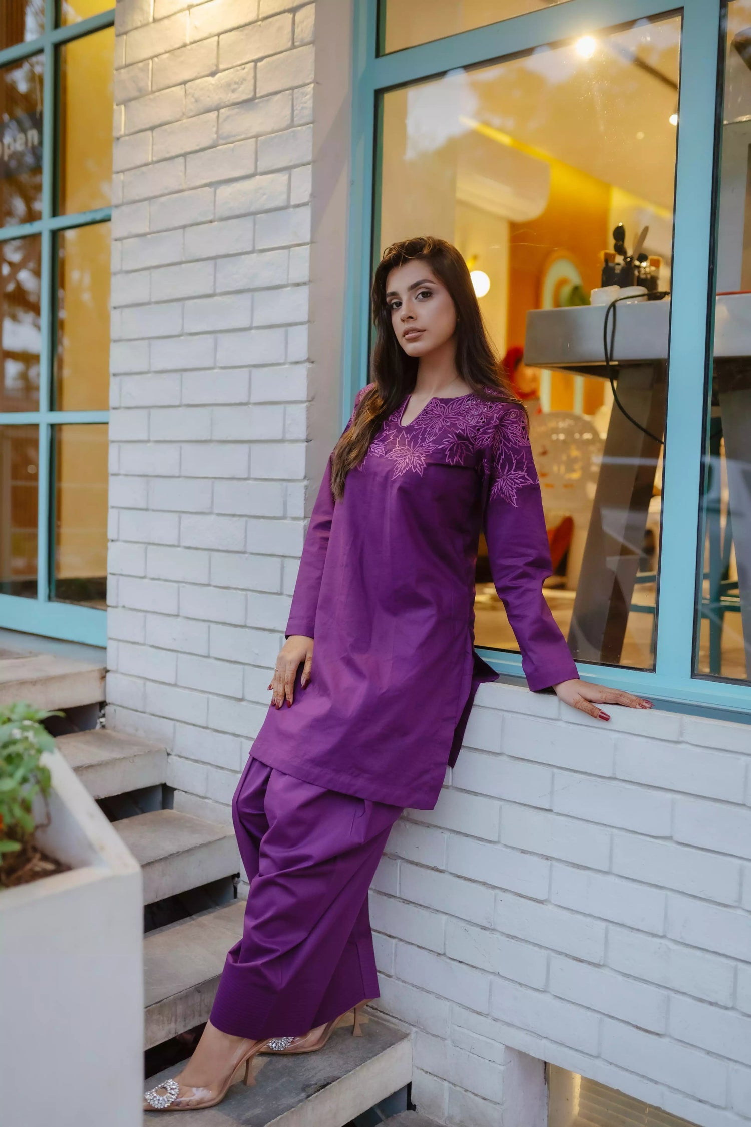 Woman wearing plum embroidered kurta with farshi shalwar