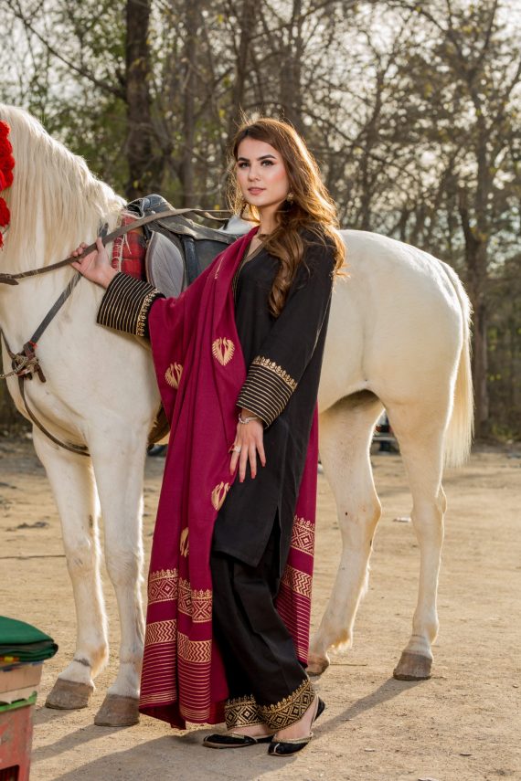 Black dress shop with red shawl