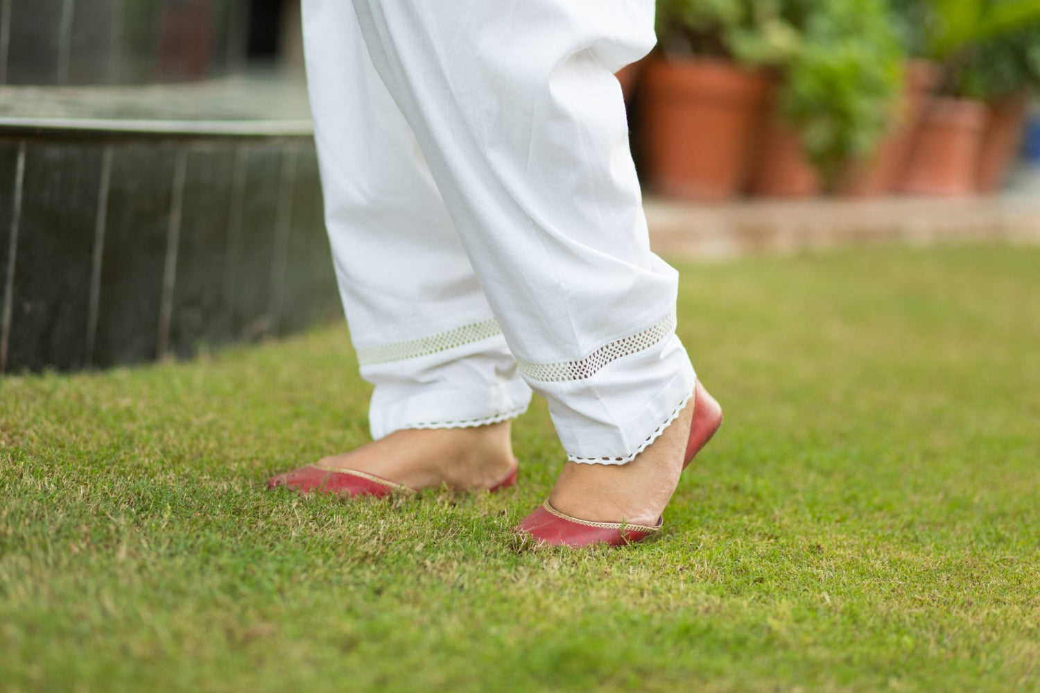 Traditional white cotton shalwar with lace-edged hem and center fill
